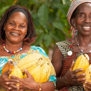 two women with cocoa pods