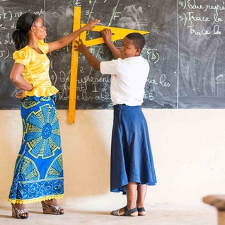 teacher and pupil by blackboard